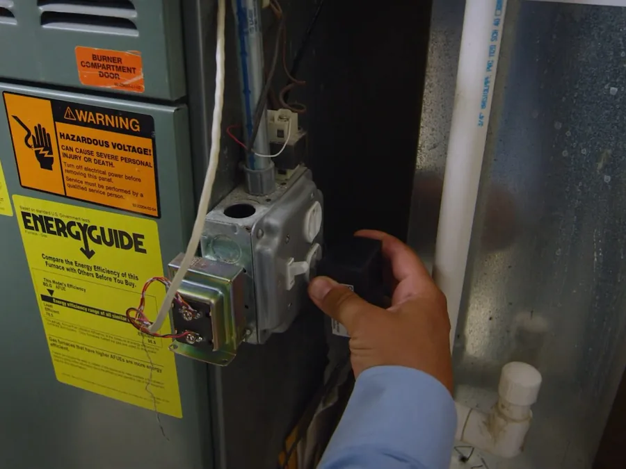 gas piping connection being checked near an appliance shown as secondary detail for Gas Line Installation & Repair in Glendora, CA