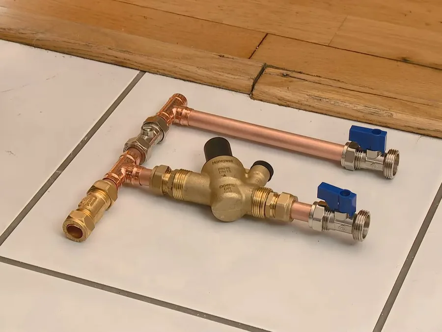 pressure valve assembly laid out on a tiled floor before installation shown as secondary detail for Water Pressure in Glendora's Hillside Neighborhoods: When You Need a Pressure-Reducing Valve